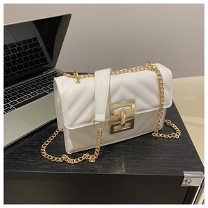 Detail of white quilted crossbody bag with golden chain and metallic turn-lock closure