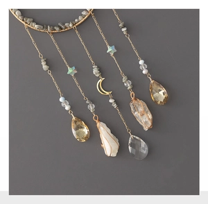 Detail of bohemian tree of life suncatcher with crystal tears and natural stones