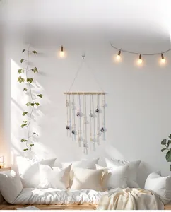 Bohemian wall decor detail featuring natural raw stones and wooden beads on woven cords