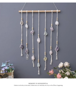 Detail of bohemian handmade woven wall hanging with natural crystals and wooden beads