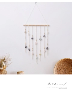 Detail of bohemian wall hanging featuring natural gemstones and cotton woven mesh bags