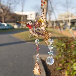 Handmade hummingbird suncatcher with colorful crystals and natural raw stones for garden decor