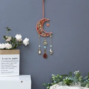 Detail of moon sun catcher with natural stones, gold chains and agate slice