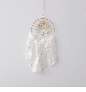 Detail of crystal suncatcher with dried flowers and shimmering bubble texture pendants