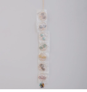 Detail of 7 chakra tree of life suncatcher with natural crystal stones and metal wire