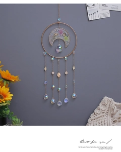 Detail of dream catcher wall hanging with crystals, dried flowers and golden metal ring