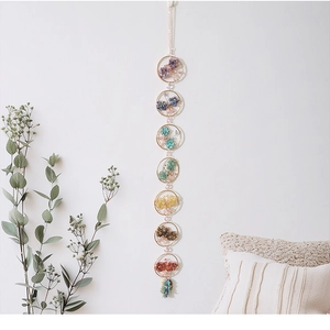 Close-up of bohemian chakra suncatcher with seven colorful crystal stone butterflies
