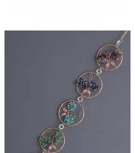 Close-up of handmade rose gold wire butterfly suncatcher with colorful crystal stones