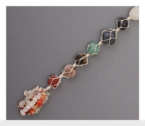 Close-up of seven chakra raw stones wrapped in handmade woven cotton mesh for car decor