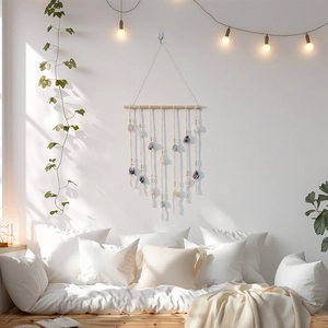 Bohemian wall hanging with natural crystals and cotton tassels on a wooden rod