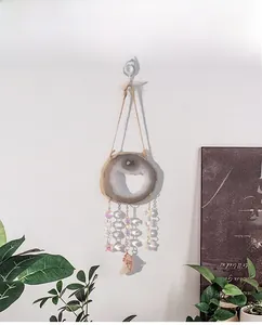 Detail of natural agate slice wind chime with colorful crystal beads and rose quartz stone