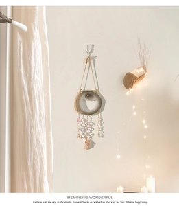 Detailed view of natural agate slice wind chime with colorful crystal beads and a warm glow