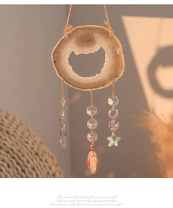 Detail of bohemian agate slice wind chime with crystal beads and metal wire wrap