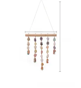 Detail of wooden wall hanging with raw crystal stones in woven nets and stone clusters