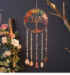 Detail of handmade crystal tree of life dreamcatcher with colorful chakra stones and hanging gems