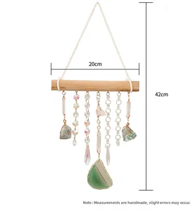 Bohemian wall decor with natural crystal stones and agate slice on wood branch
