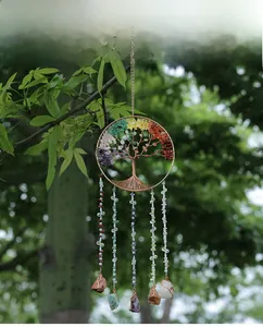 Detail of tree of life wind chime with colorful natural crystals in garden setting