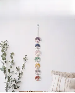 Detail of life tree wall hanging with seven natural chakra stones on white wall background