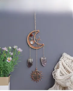Detail of moon sun wall decor with amethyst crystals and bronze wire wrapping