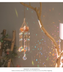 Close-up of golden geometric suncatcher casting rainbow light reflections on a wall