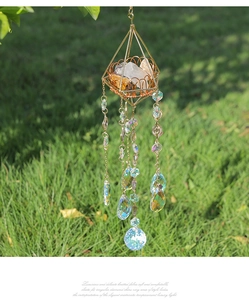 Detailed view of golden geometric suncatcher featuring raw crystals and prismatic beads