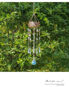 Detail of golden geometric suncatcher with purple crystals and sparkling prism ball