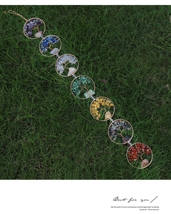 Detail of handmade seven chakra tree of life wind chime with natural healing crystals