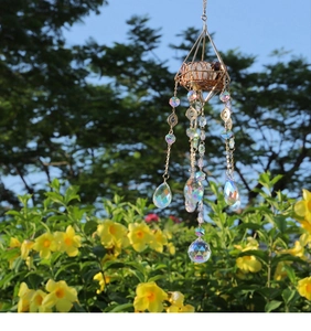 Detail of golden geometric suncatcher with raw stones and iridescent crystal pendants