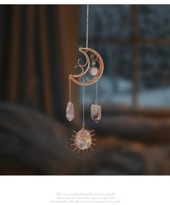 Detailed wire-wrapped crescent moon and sun ornament with natural amethyst crystals