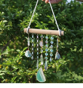 Detail of a natural crystal dreamcatcher with agate slices and clear quartz pillars