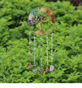 Detail of life tree suncatcher with natural colorful crystals and copper wire weaving