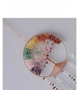 Detail of life tree chakra suncatcher featuring natural crushed crystals and bronze wire