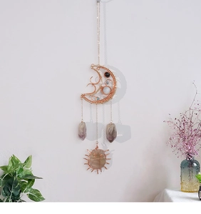 Detailed wall hanging with moon wire frame, purple amethyst, and sun crystal pendant