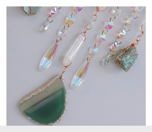 Detail of natural agate slices and crystal prisms with handcrafted copper wire wrapping