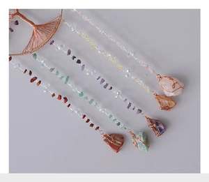Detail of Tree of Life crystal suncatcher with natural colorful raw gemstone tassels