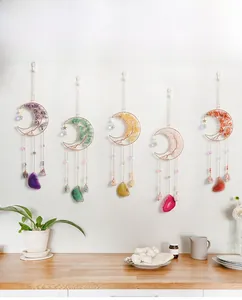 Detailed close-up of natural crystal moon suncatchers with amethyst and agate slices