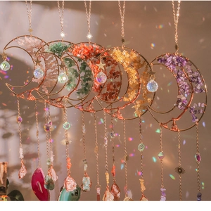 Detail of amethyst moon suncatcher with crystal tree of life and rainbow reflections