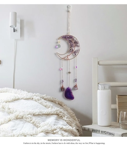 Detail of amethyst moon suncatcher featuring crystal stones and purple agate slice on wall