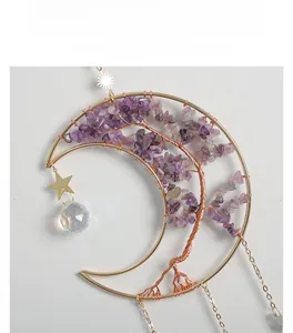 Macro detail of Tree of Life moon pendant with purple amethyst stones and crystal ball