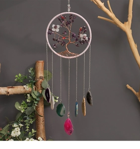 Detail of life tree crystal suncatcher with pink frame and polished agate slices