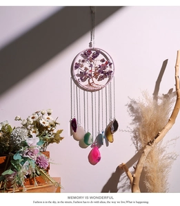 Detail of life tree suncatcher with purple crystals and colorful agate slices for wall decor