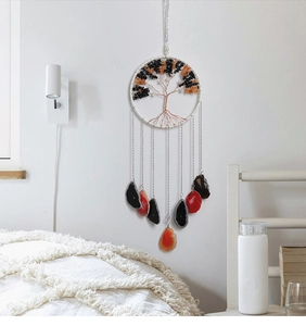 Detail of life tree wall hanging with natural quartz stones and agate slices on white wall