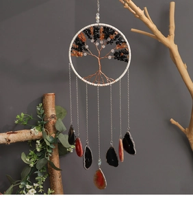 Detail of tree of life wind chime with natural crystal stones and agate slice pendants