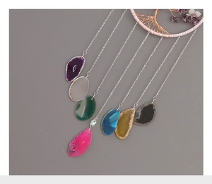 Detail of life tree suncatcher showing colorful natural agate slices and metal chain