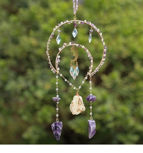 Detailed view of amethyst crystal chips and golden moon charm on a suncatcher wind chime