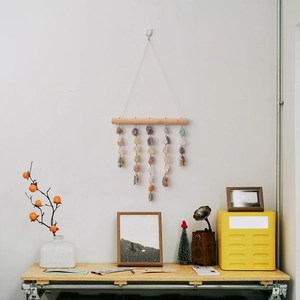 Bohemian raw crystal wall hanging with natural stones on a wood stick for home decor