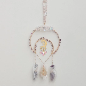 Detail of amethyst suncatcher with golden crescent moon and crystal beads on rings
