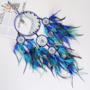 Handmade dream catcher wall hanging with blue feathers and crystal stones for home decor