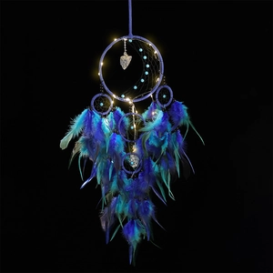Blue and purple dream catcher with feathers and LED lights on black background