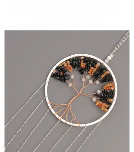 Detail of Tree of Life wall hanging with natural crystals and long metal chain tassels